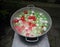 White, red and green mini water balloons in tin bucket