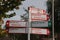 White and red letters signpost sign for cyclists to rotterdam and other villages in the area