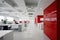 White and red office interior, comfortable workplaces. Generative ai