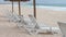 White relax chairs in beach close to ocean, Portugal