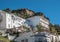 White residental buildings at a shoulder of big rock