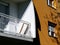 White residential balcony detail of modern design with orange stucco exterior