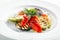 White Restaurant Plate of Grilled Vegetables and Fresh Greens Isolated