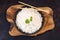 White rice on a black plate with chopsticks on a wooden table.