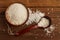 White rice in a ceramic bowl and spoon on a wooden table