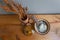 White rice in a earthen brown pot with dried flowers in terracotta vase put on a wood table and gray wall