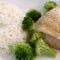 White rice with fish on a white plate. Broccoli rice and fish. Photography food close up