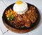 white rice with minced beef and half boiled egg served on a hot plate..yummy