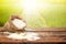 White rice in small burlap sack on wooden table