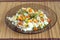 White rice with vegetables on plate over wicker mat