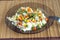 White rice with vegetables on plate over wicker mat