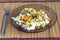 White rice with vegetables on plate over wicker mat