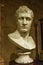White roman bust of man on plinth