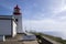 White romantic lighthouse on the cliff, west Madeira island, village Ponta do Pargo, Portugal, Atlantic ocean