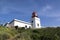 White romantic lighthouse on the cliff, west Madeira island, village Ponta do Pargo, Portugal, Atlantic ocean