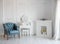 White room with blue retro chair and mirror