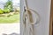 White Rope on Door Hook in Sunny Suburban Home