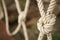 White rope tied in a knot for adventure. Close-up of rope knot line tied together