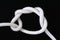 A white rope tied with timber hitch knot on black background