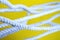 White rope on a yellow background. Rope close-up.
