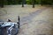 White and rose bicycle lays on the abandoned path in a park or forest in a lovely autumn day. Nobody is around, calm and relax amb