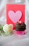 White rose, blank Valentine with chocolate frosted cupcake