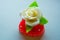 White rose with green leaves on a red marmalade heart, sweets for lovers and weddings.