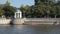 White rotunda and green trees on Moskva river embankment