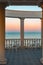 a white rotunda with tables and chairs. Sea view