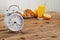 White round alarm clock on a wooden table