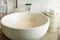 White round bathtub. Modern white house bathroom bathtub. Bathroom interior in cozy colors with modern bathtub.