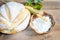 White round bread with some wheat ears, white flour and olive oil on the wooden kitchen table. Natural handmade bread