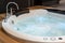 White round jacuzzi with swirling water in the bathroom
