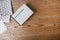 White round pills in aluminum packaging and white box of pills on a wooden table, copy space