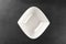 White round plate for food on dark background. Empty dishes for dinner isolated on stone. Restaurant kitchen