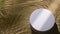 White round podium on sand and water wave, ripple, splash and tree leaf shadow