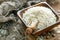 White round rice in a wooden bowl close up.