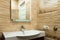White round sink with mirror brown bathroom tiled mosaic walls background