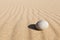 White round stone lying on clean sand. Concept of balance, harmony and meditation. Minimalism