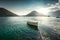 White rowboat moored at bay surrounded by mountains