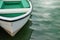 White rowboat moored near shore.