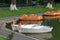 White rowing boats and orange catamarans