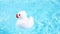 A white rubber duck floats easily and swims