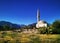 A white rural mosque on the background of mountains