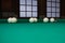 White russian billiards balls position on green game table cloth