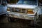 A white and rusty ford truck in the country