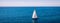 White sail boat isolated in blue sea water. Sailboat in the sea in the sunlight, luxury summer adventure, active vacation in