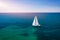 White sail boat isolated in blue sea water. Sailboat in the sea in the sunlight, luxury summer adventure, active vacation in