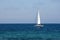 White sail on a yacht in the blue sea