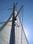 White sail and yacht mast
